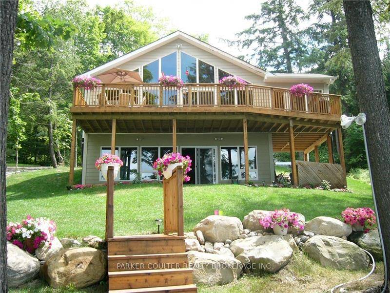 Discover the perfect getaway at this charming 2 storey home nestled on the shores of Three Mile Lake.