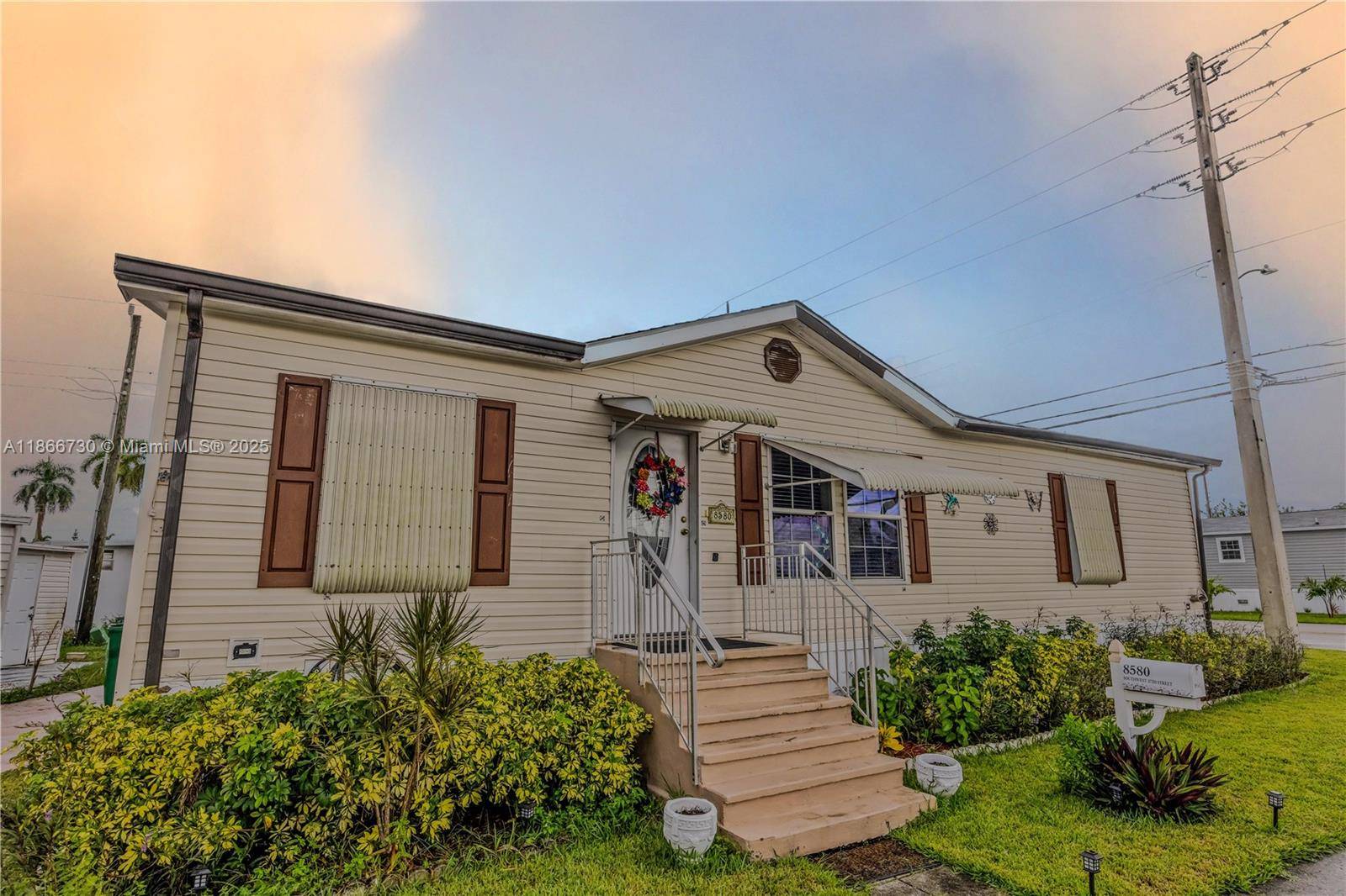This spacious three bedroom two bath double wide manufactured home built in 2006 features central AC with enclosed window and screened tiled porch.