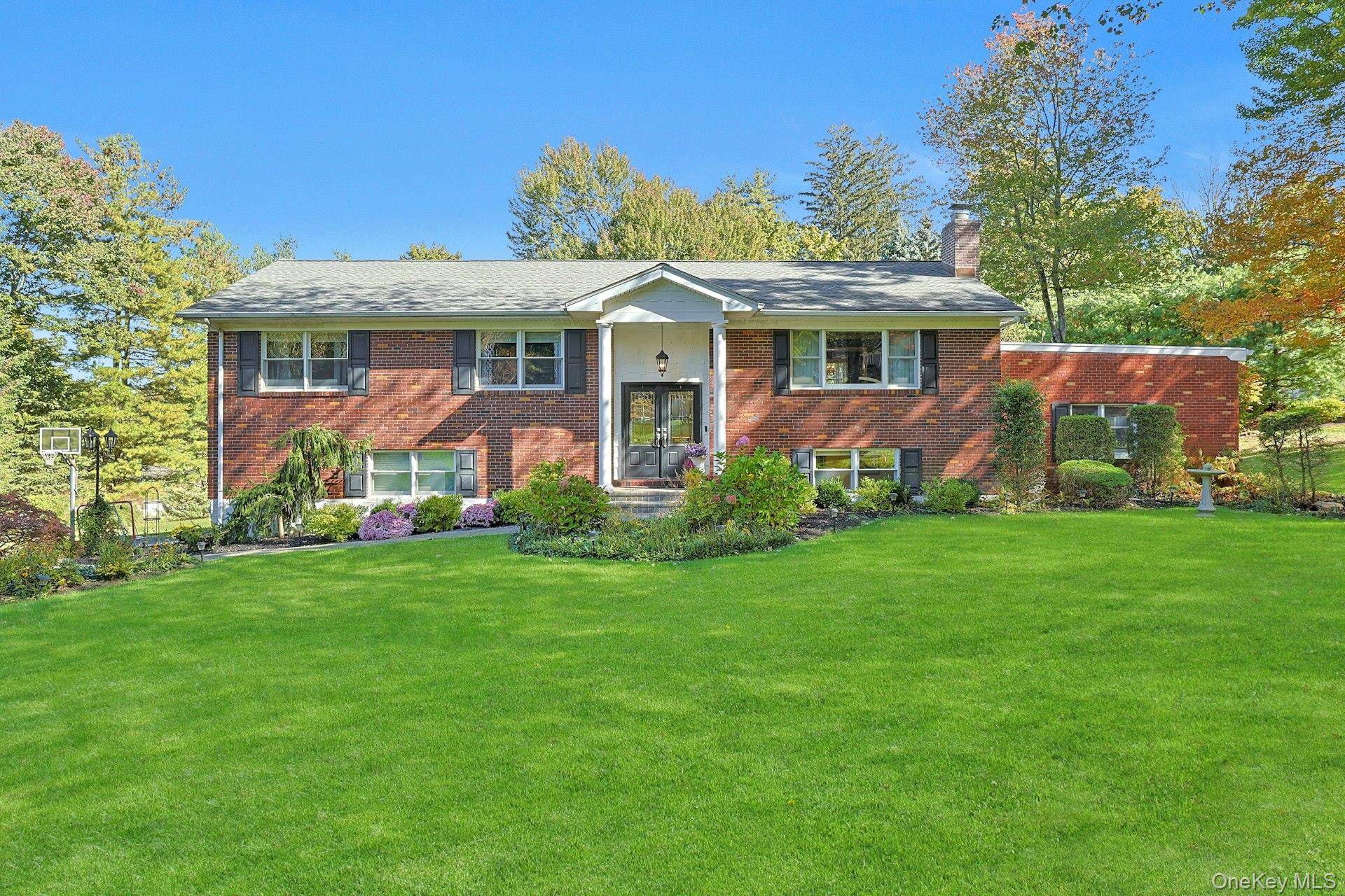 Welcome to this stunning brick Raised Ranch, privately nestled on a serene.