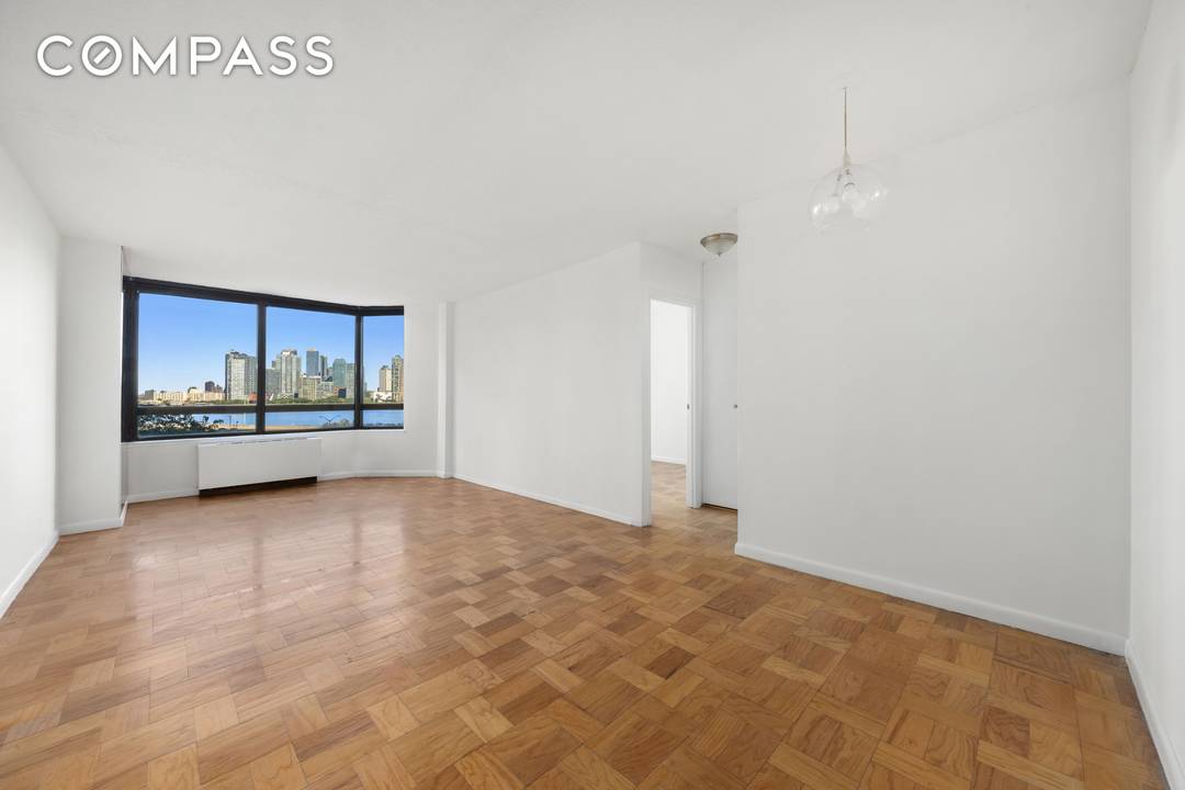 This spacious one bedroom, one bath residence offers unobstructed views of the East River framed by wall to wall windows that bathe the interiors in natural light.