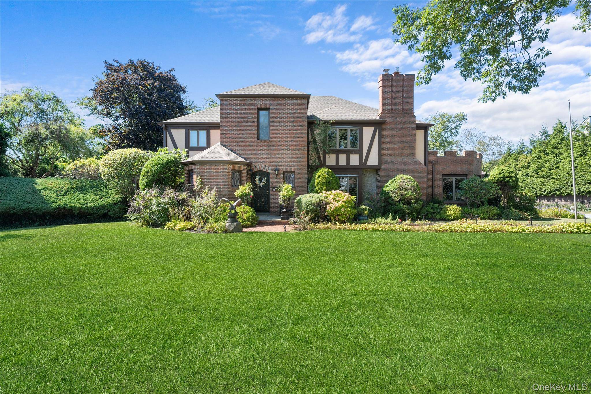 Behind stately wrought iron gates, this distinguished Tudor style estate unfolds like a private compound, blending timeless architecture, modern luxuries, and resort style amenities in one extraordinary offering.