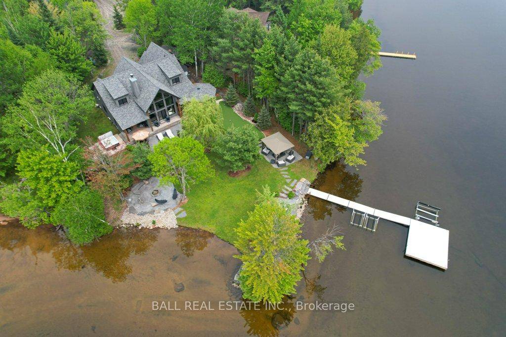 Luxury Lakehouse on one of Drag Lake's most stunning sand beach point lots.