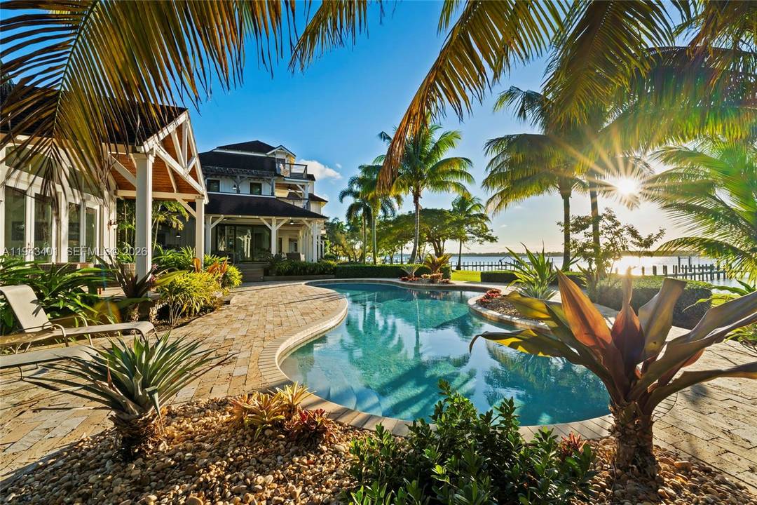 Set on more than 1. 2 acres along a breathtaking stretch of riverfront in North River Shores, this exceptional home captures the essence of coastal Florida living.