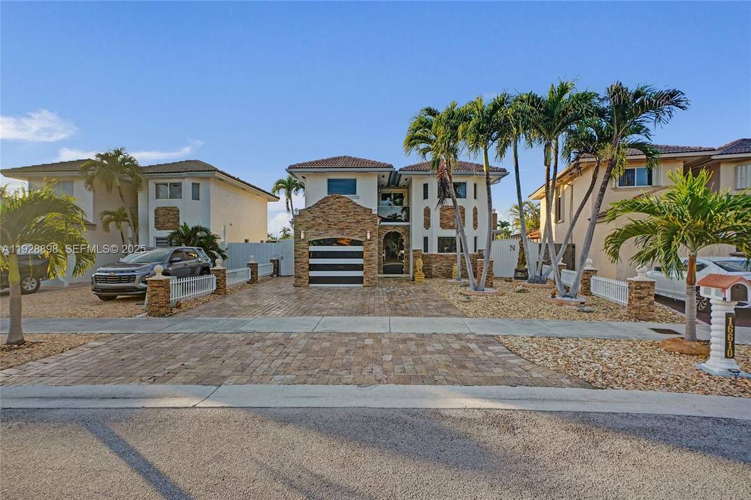 This beautifully upgraded Miami home features a custom extended second floor balcony, elegant glass doors, and an updated kitchen.