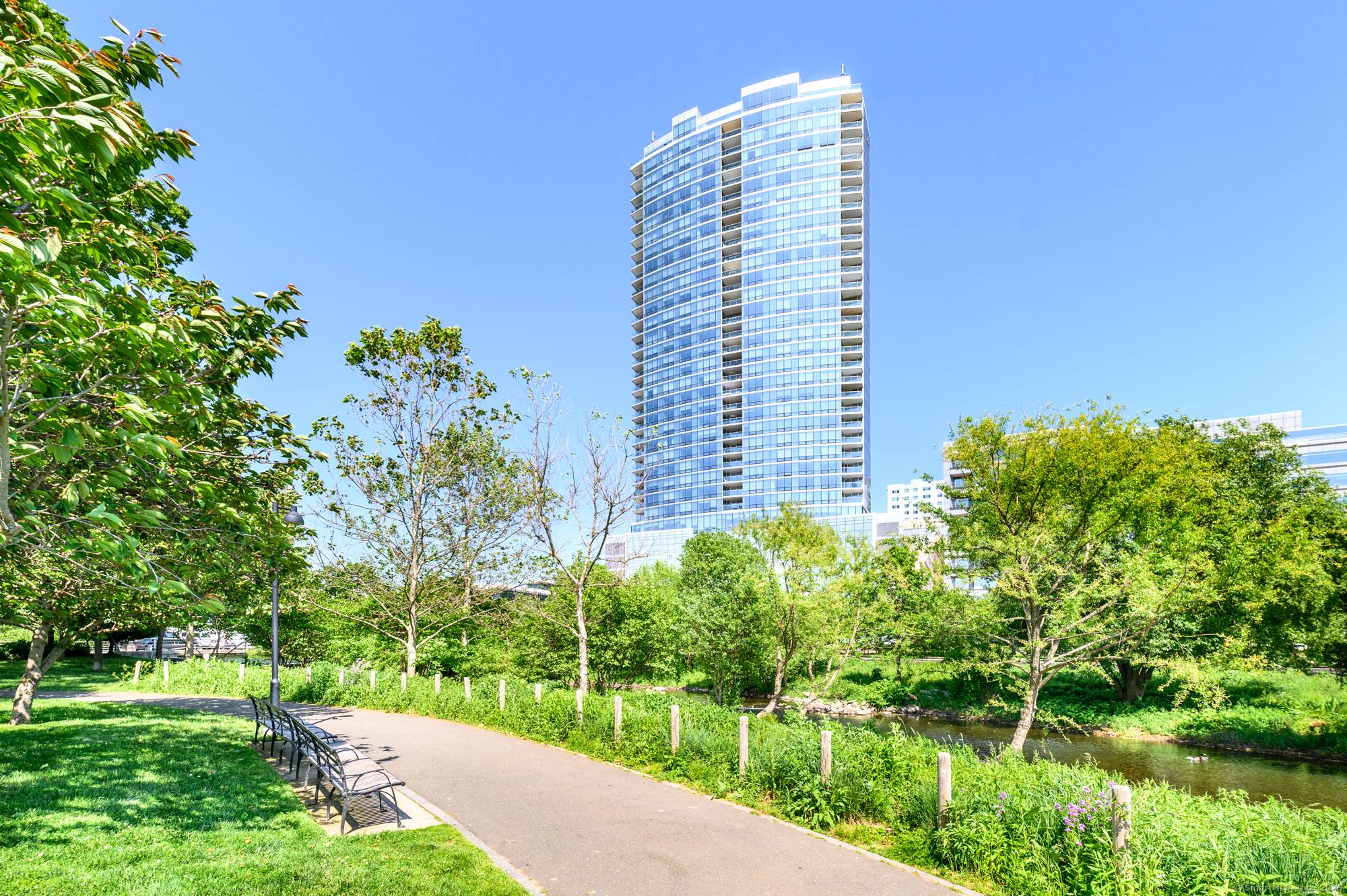 Experience luxury living in this sun drenched corner unit at Park Tower, a pet friendly high rise in the heart of vibrant downtown Stamford.
