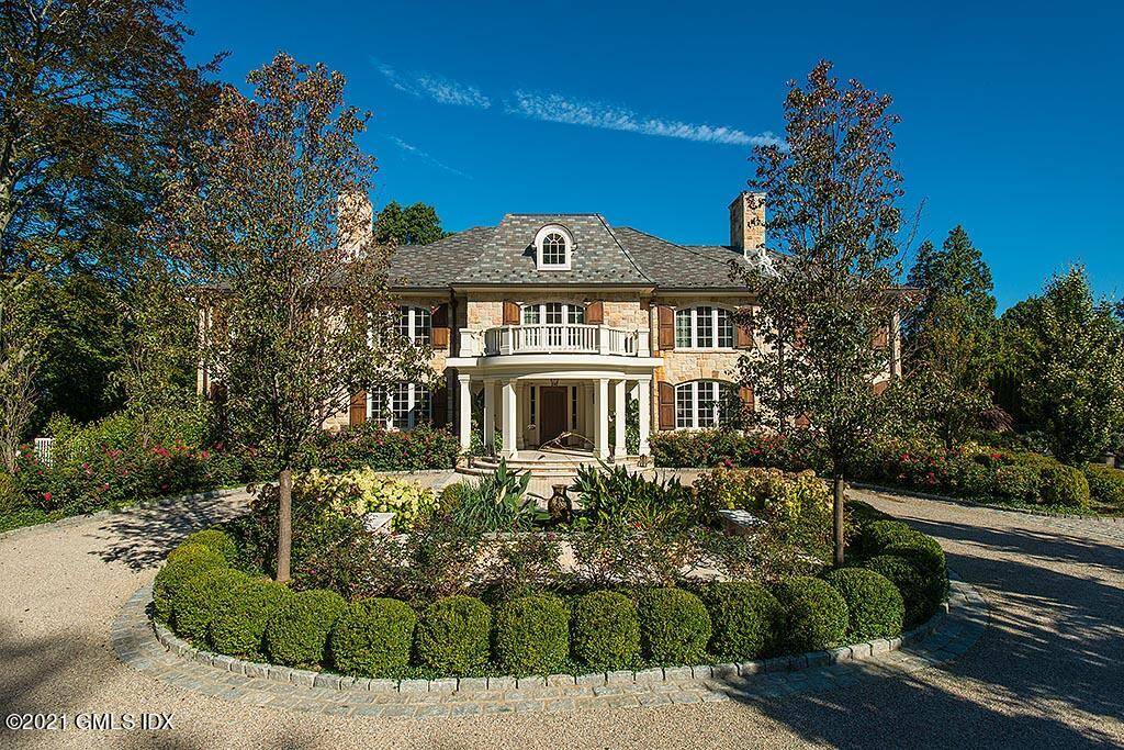 Extraordinary Belle Haven peninsula stone manor style 7 bedroom home completely rebuilt and expanded in 2012.