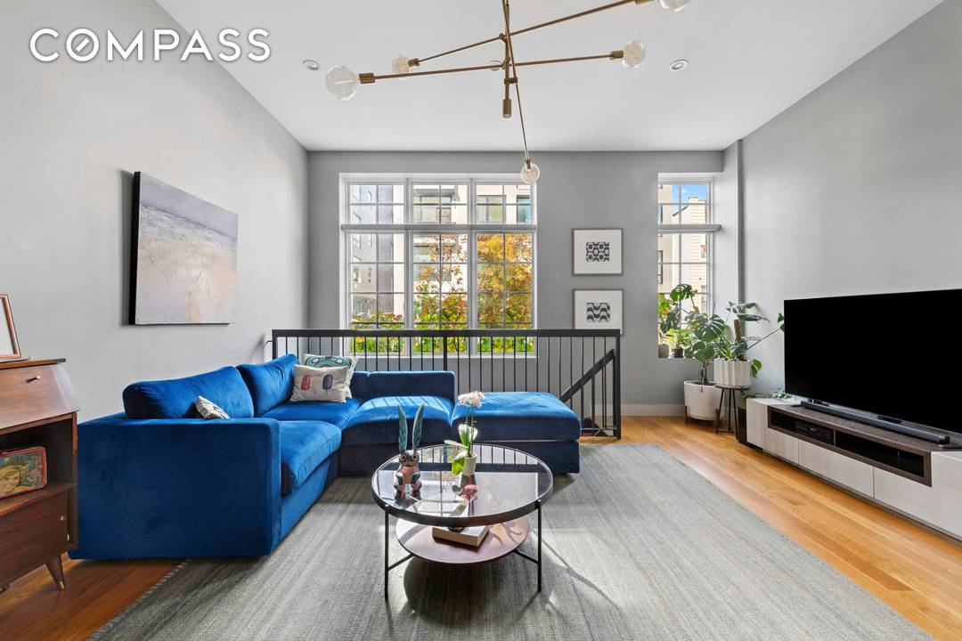 Experience the best of indoor outdoor living in Unit 1A, a dramatic duplex offering approximately 918 sq.