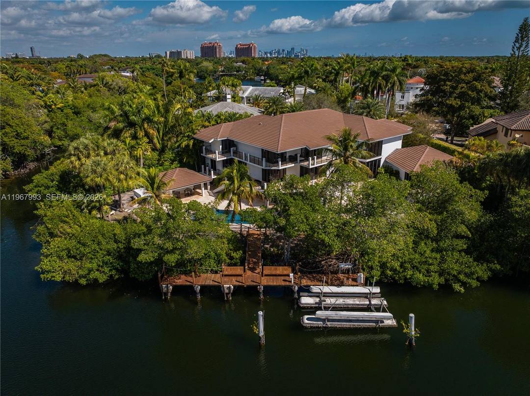 Located on the exclusive island of Cocoplum Phase II, this rare waterfront estate presents an exceptional opportunity within one of South Florida's most prestigious guard gated communities.