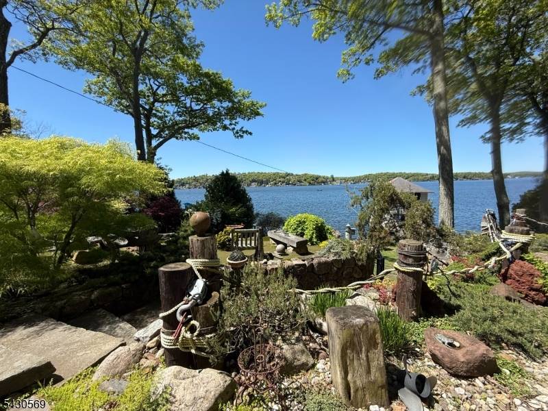 Welcome to this Laketastic waterfront Sunset Cove Retreat at 501 Windemere Ave in beautiful Mount Arlington !