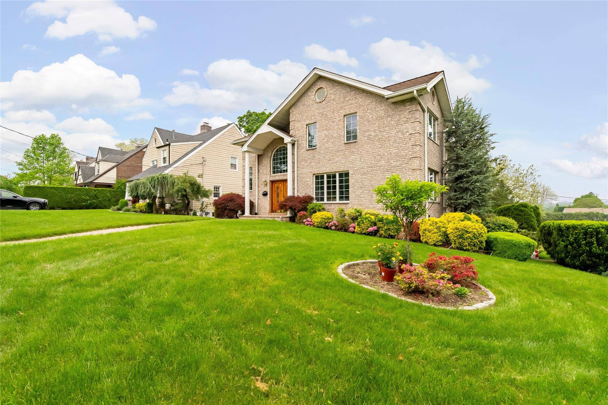 This elegant full brick colonial sits on a prominent corner lot and welcomes you with Grecian columns and double doors into a entry way with soaring ceilings, oversized windows and ...