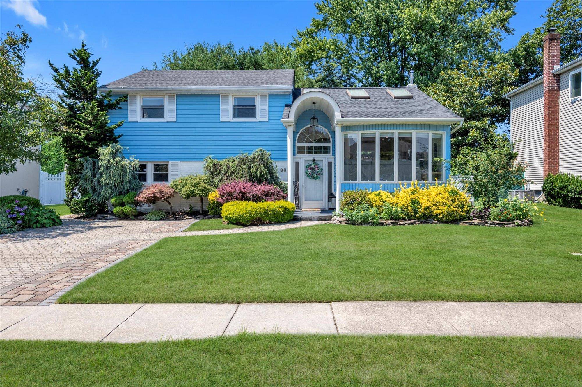 This beautifully renovated split level home in Syosset features vaulted ceilings and an open layout connecting the living, dining, and kitchen areas to a bi level deck and private yard.