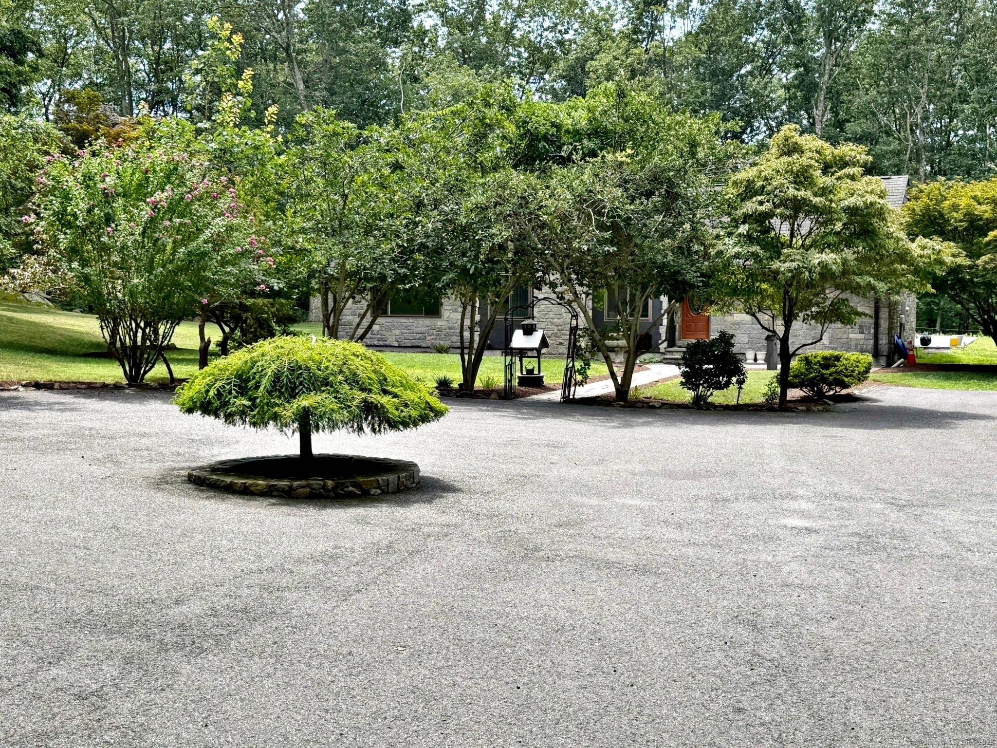 Privacy abounds in this beautifully maintained single family home set on over 2 acres of serene land.