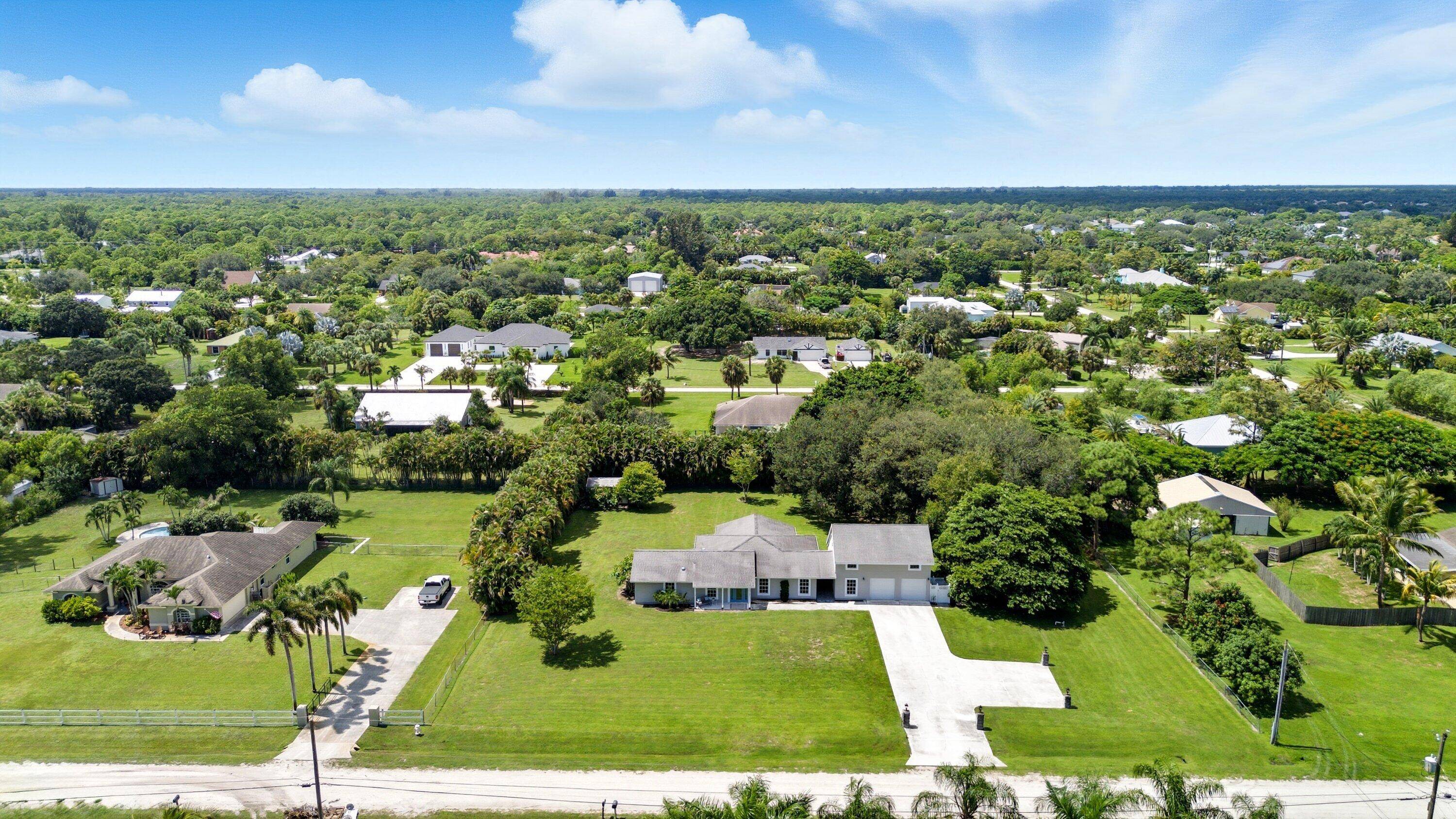 Do not miss this rare opportunity in Palm Beach Country Estates featuring the perfect combination of a spacious single family home and a detached in law suite apartment.