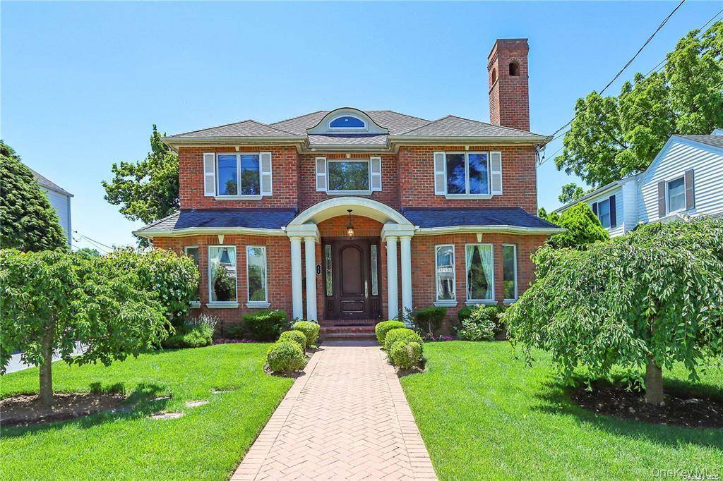 Better Than New ! This stunning all brick Center Hall Colonial offers timeless elegance and modern comfort.