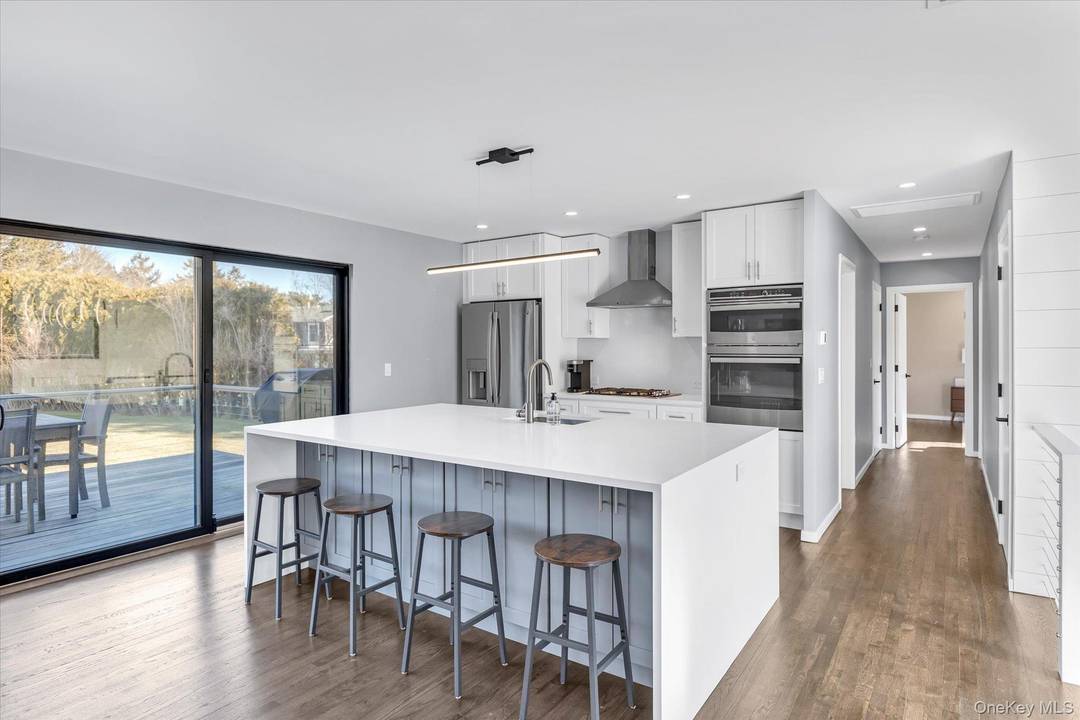 Recently completed and fully staged, this impeccably priced five bedroom residence sits on a generous lot in a picturesque neighborhood just moments from both ocean and bay beaches.