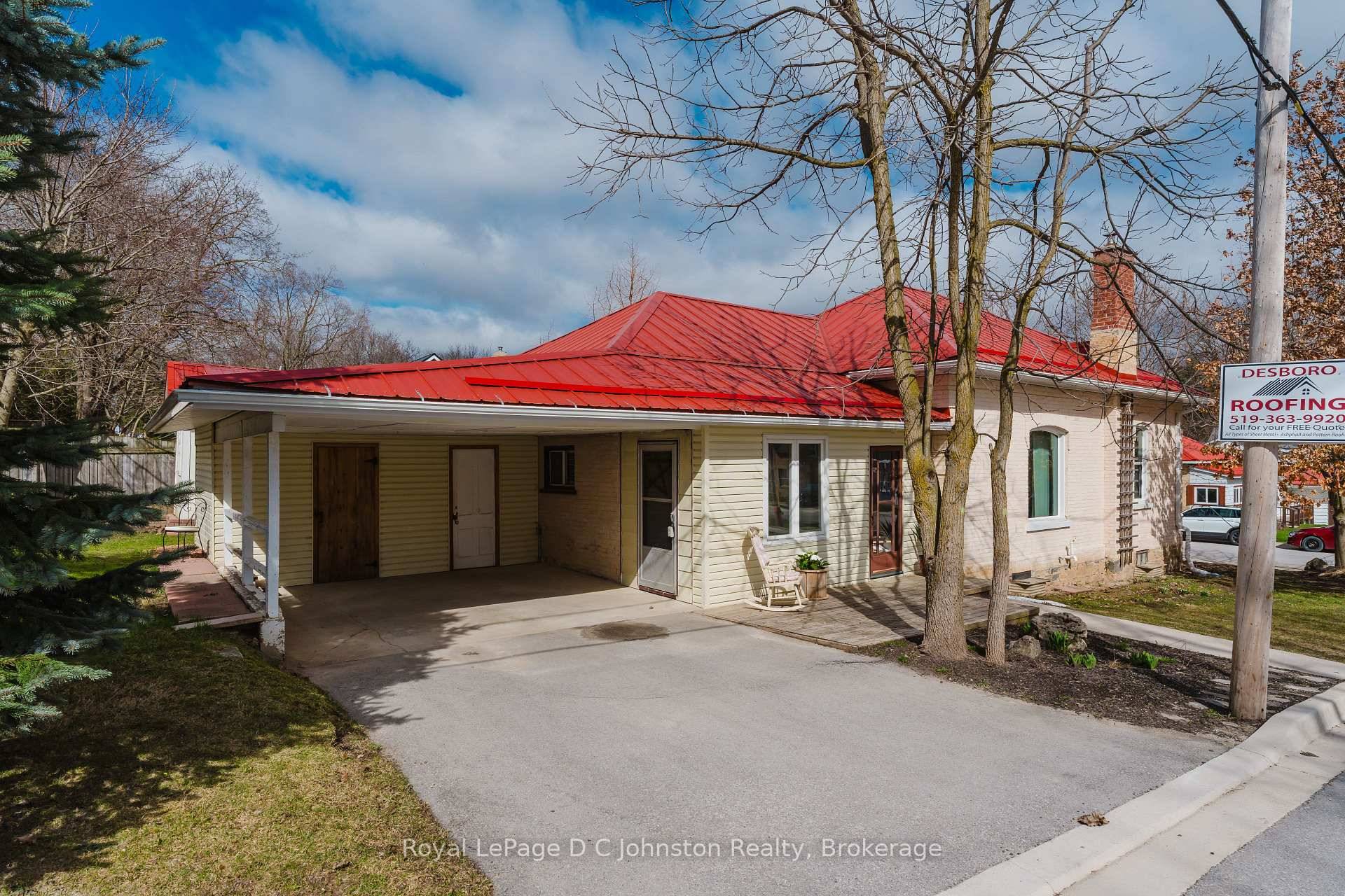 Welcome to this charming yellow brick bungalow nestled on a desirable corner lot with mature trees and perennial gardens.