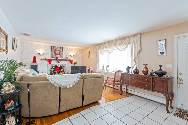 Charming one family corner home in South Plainfield with three bedrooms and a cozy fireplace.