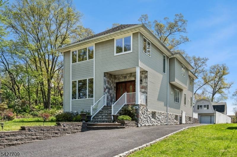 Situated near Baltusrol Golf Club in the heart of Springfield, this custom home offers 4 bedrooms, 2 full baths, and 2 powder rooms across three fully finished levels.