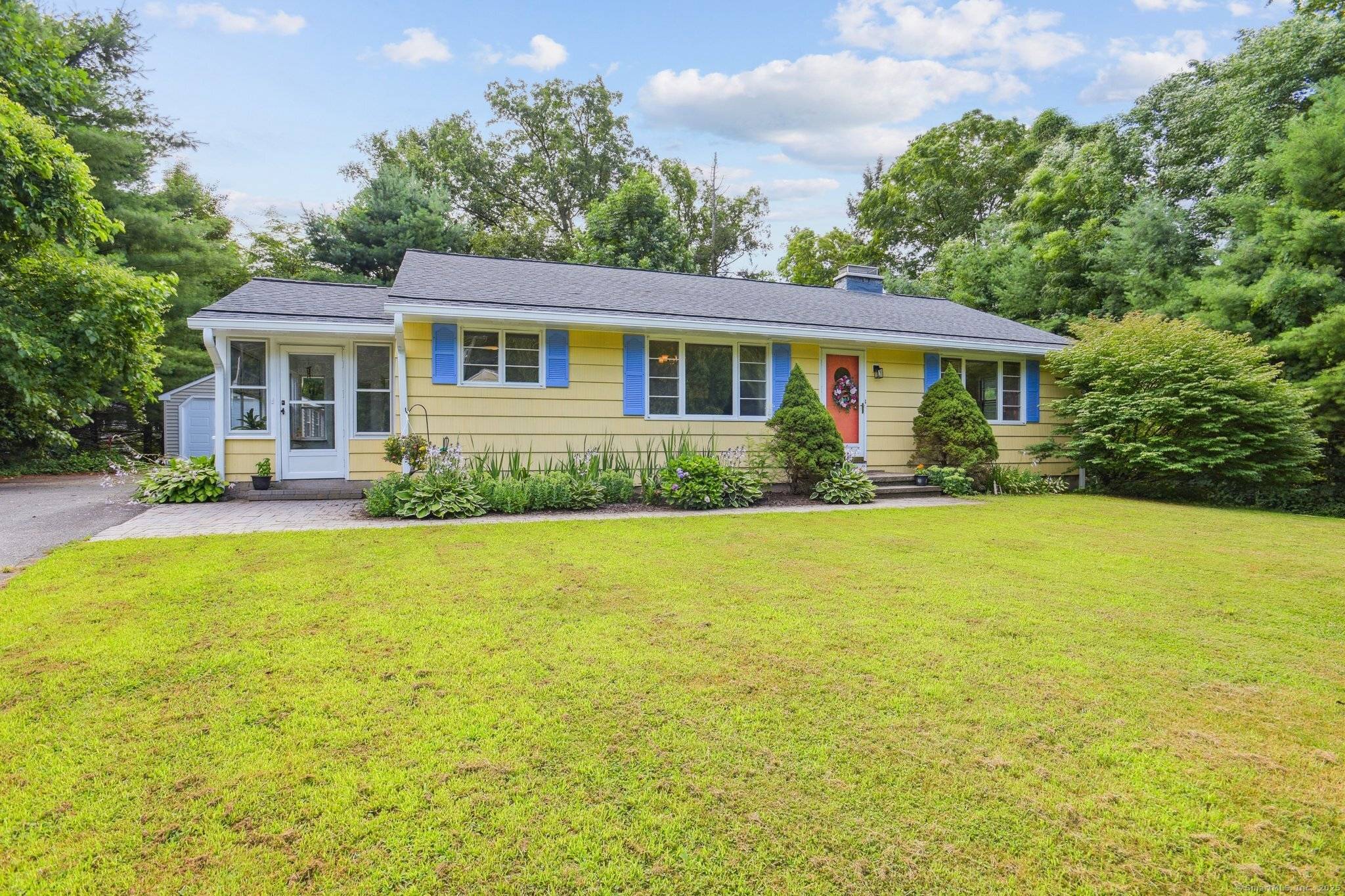 Step inside to discover a bright, open layout featuring gleaming hardwood floors, a cozy fireplace, and a cheerful sunroom ideal for unwinding or working from home.