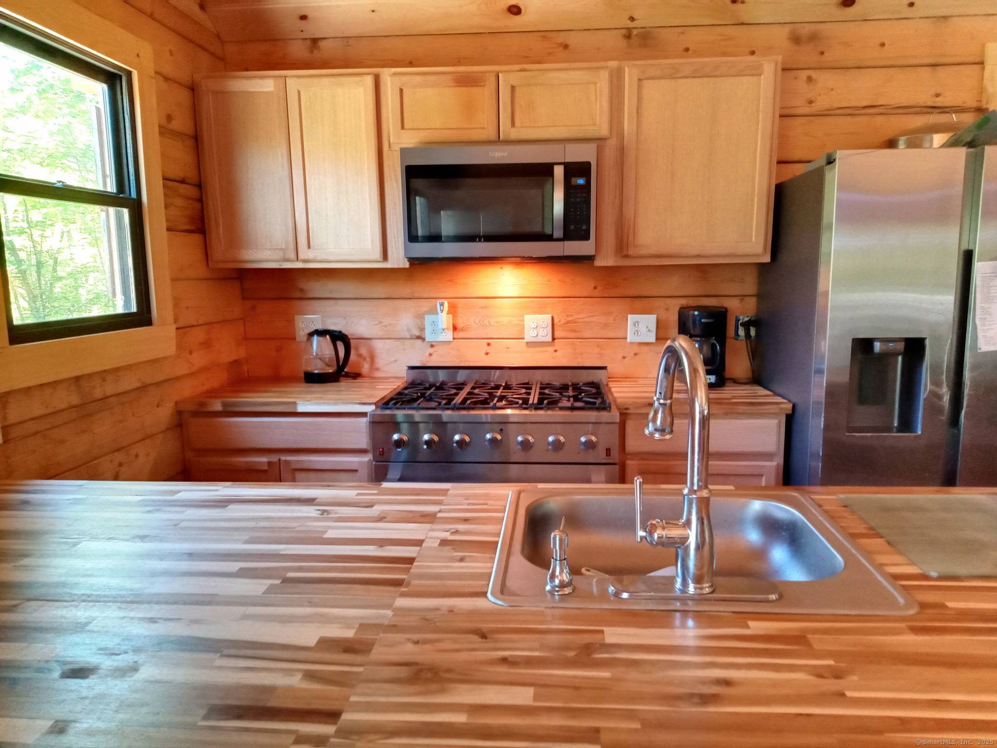 Beautiful 2 year old log home on almost 20 ACRES in pleasant rural, private location.