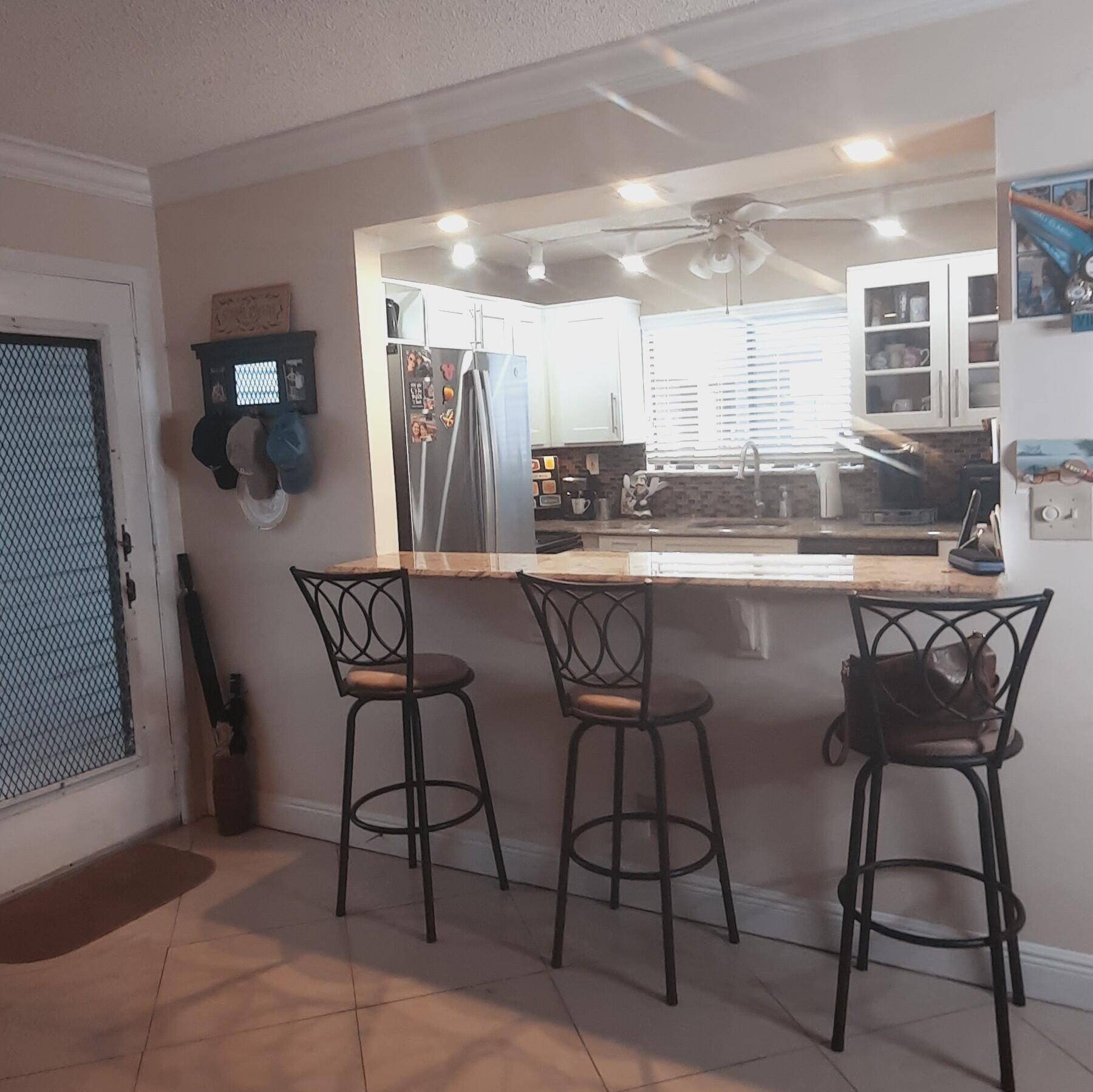 Exceptionally maintained first floor lake view condo conveniently walk to clubhouse, pool, tennis and paddle ball courts.