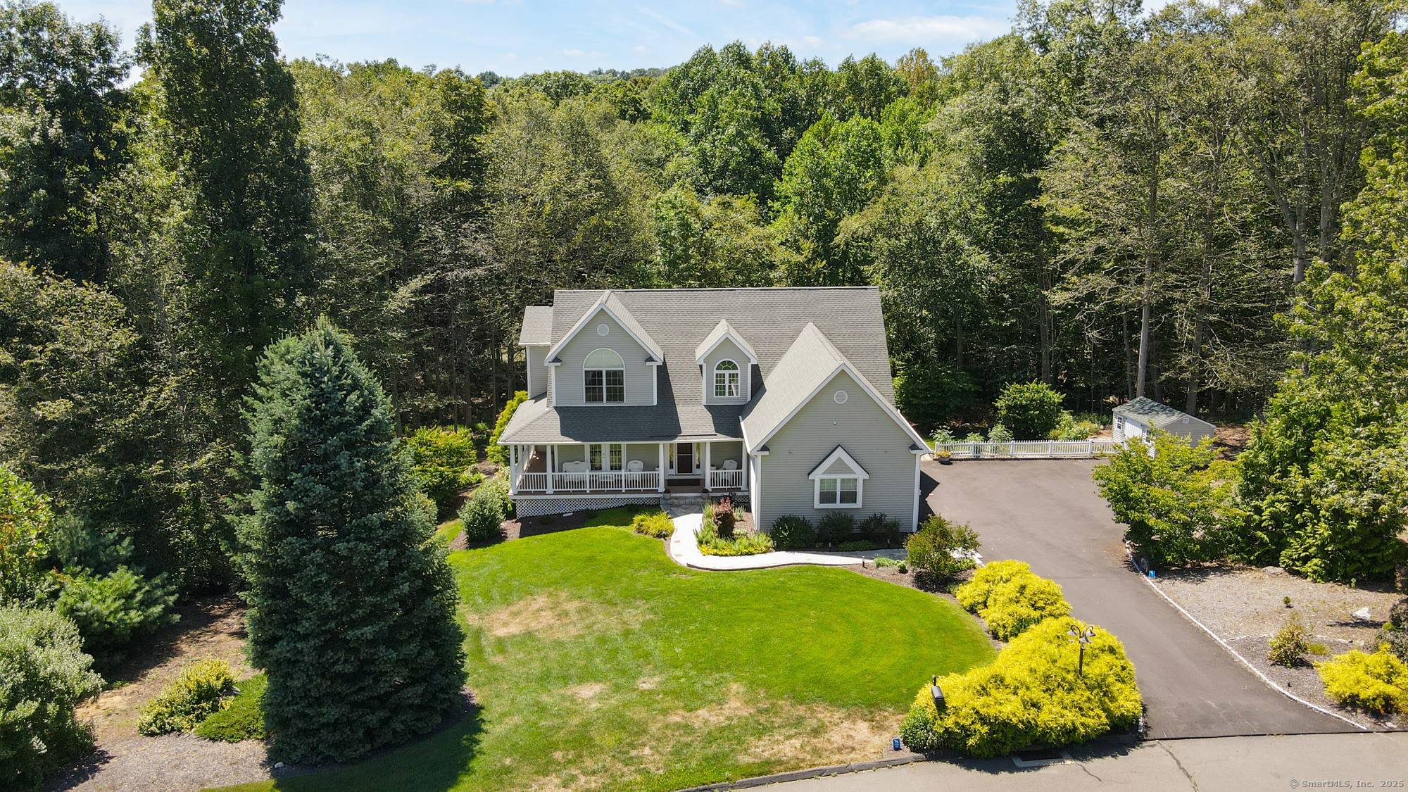 Exceptional custom built Colonial Farmhouse offering timeless charm privately nestled on.