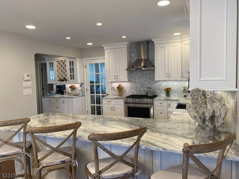 Cook, sip, entertain Your dream kitchen with wine bar awaits.