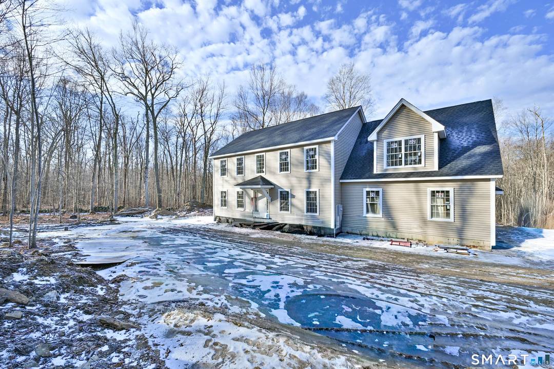 Set on a dead end road abutting the Brooklyn border, 401 Tripp Hollow is a refined new construction Colonial by one of the area's most premier builders.