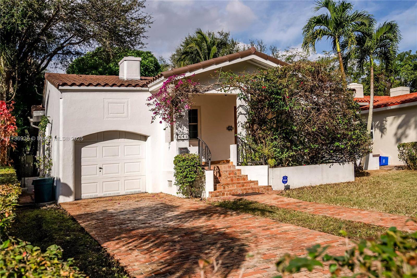 Step through this charming bougainvillea draped entry and instantly feel transported to a lush retreat.