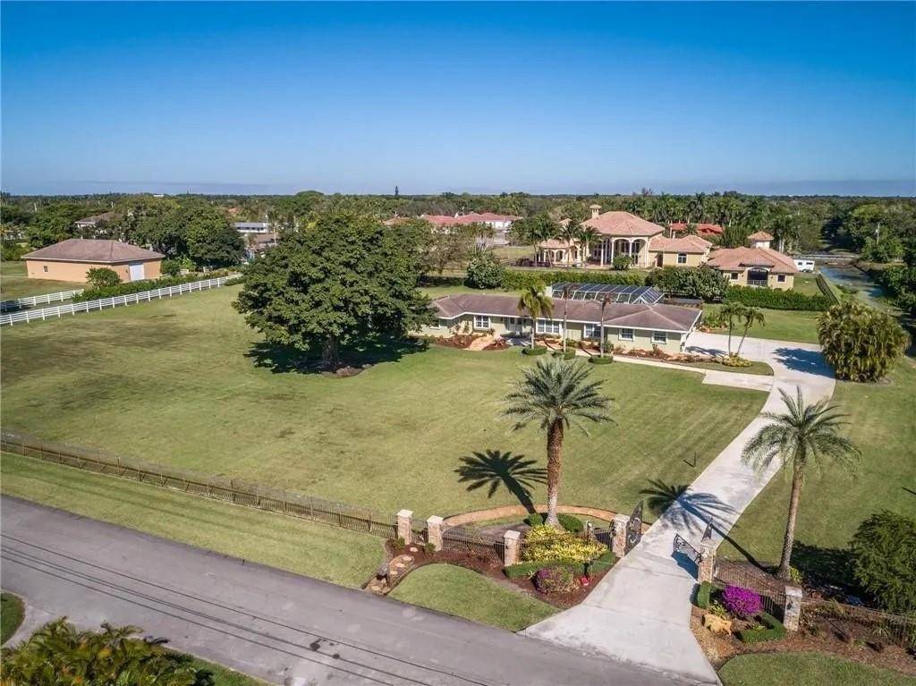 Ornate and opulent, this Pearle Lichi inspired estate is a rare opportunity nestled on three manicured acres in Rolling Oaks.