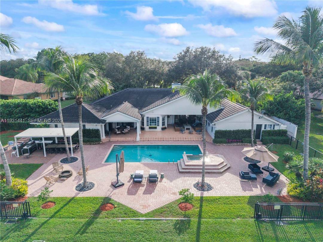 Coral Springs Incredible waterfront estate on a private cul de sac in the exclusive Whispering Woods community.