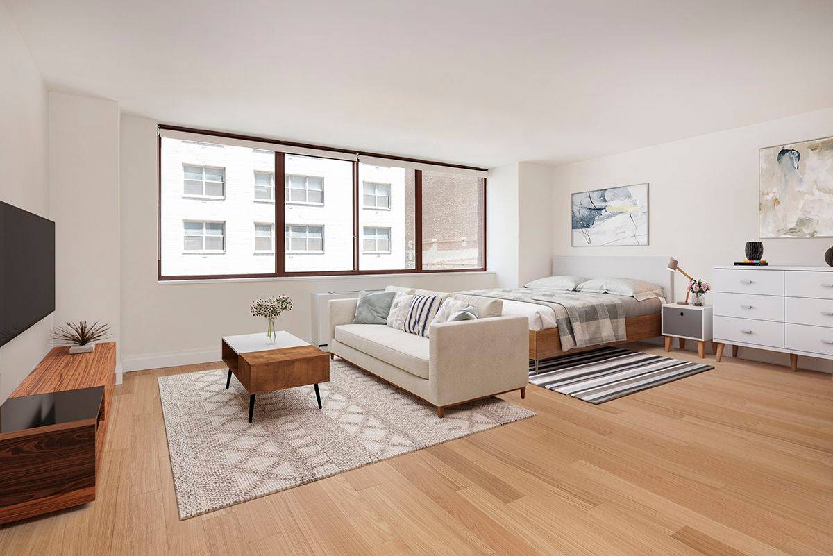 Spacious studio with windowed sleeping alcove.