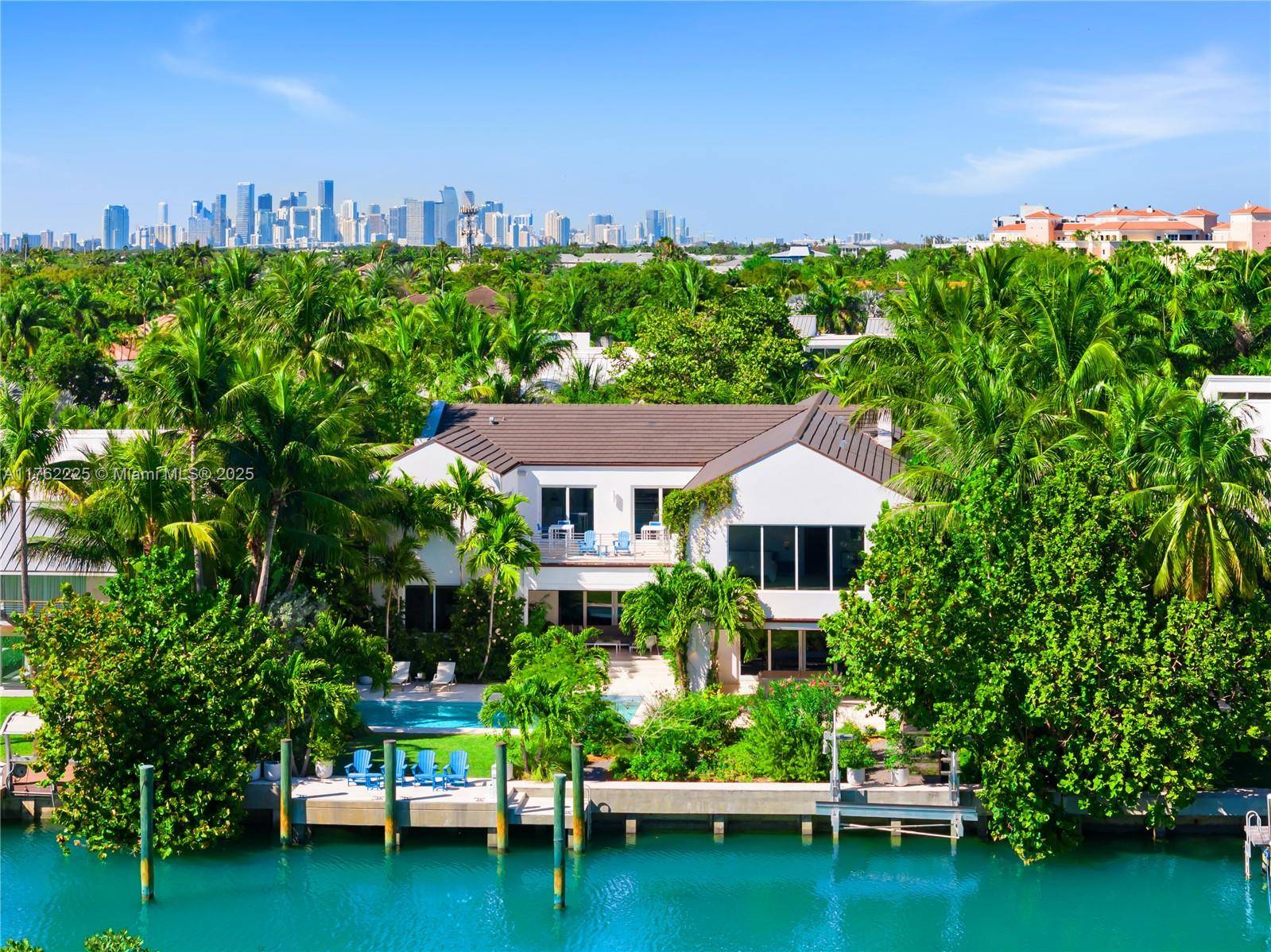 A BOATERS PARADISE WITH SERENE WATER amp ; PROTECTED LUSH GREEN TROPICAL RESERVE VIEWS FROM THIS NEW IMPECCABLE TRANSITIONAL KEY BISCAYNE WATERFRONT ESTATE !