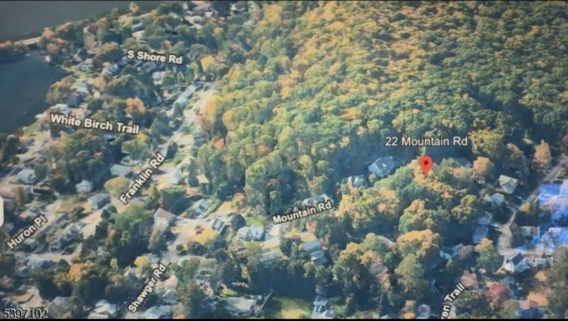 Executrix of family will selling parents undeveloped vacant wooded lot next to their previous family home.