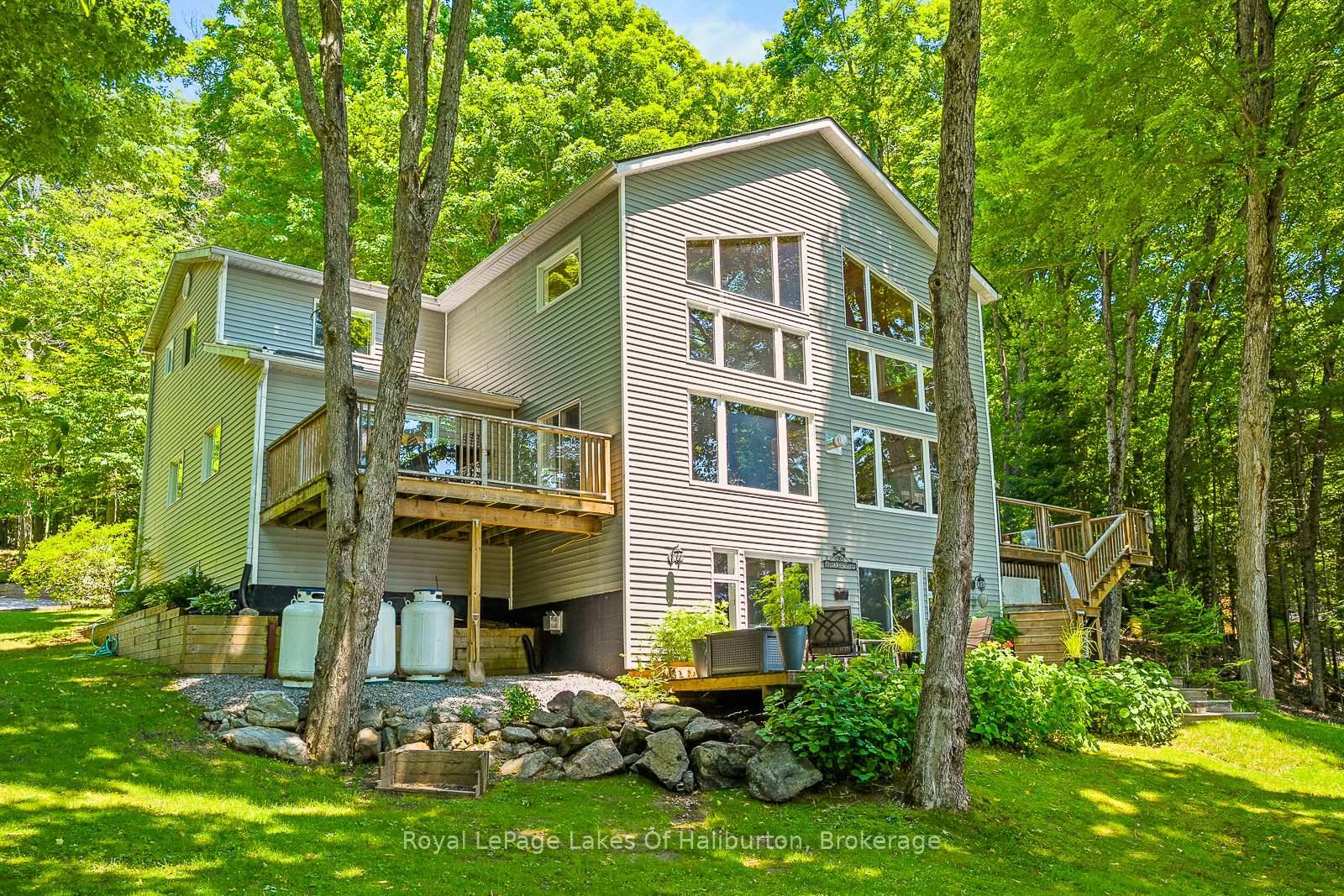 Discover your dream escape with this custom built executive year round home on the shores of quiet Trooper Lake.