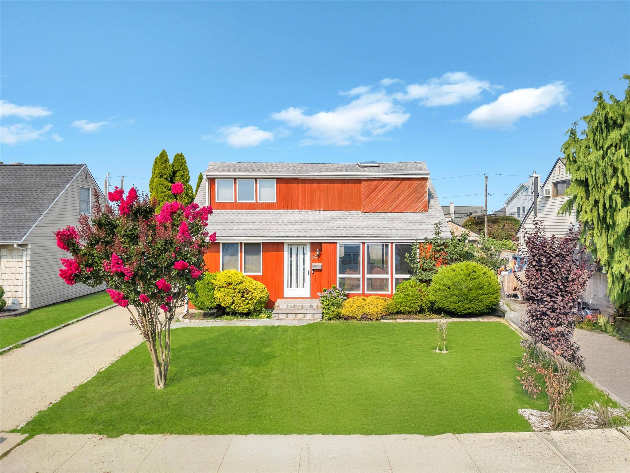 Welcome to this beautifully maintained Expanded Cape nestled on a quiet street in the heart of Hicksville.