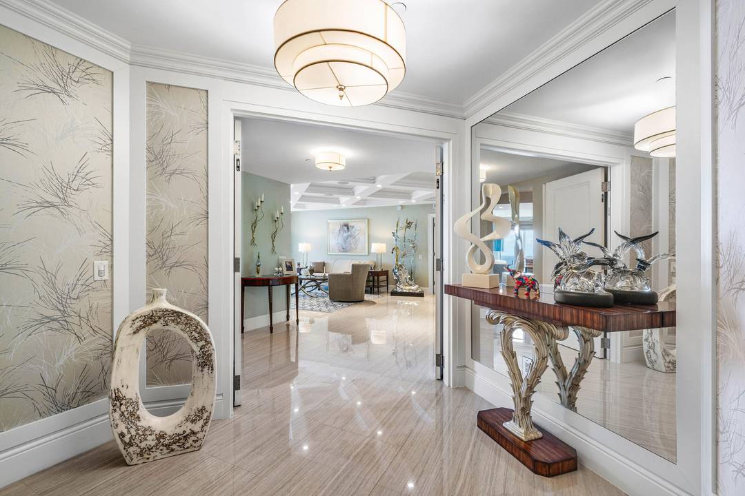A rare offering in the coveted ''02 line'' at The Ritz Carlton Residences, Singer Island, this direct oceanfront home is a masterclass in modern elegance and coastal design.