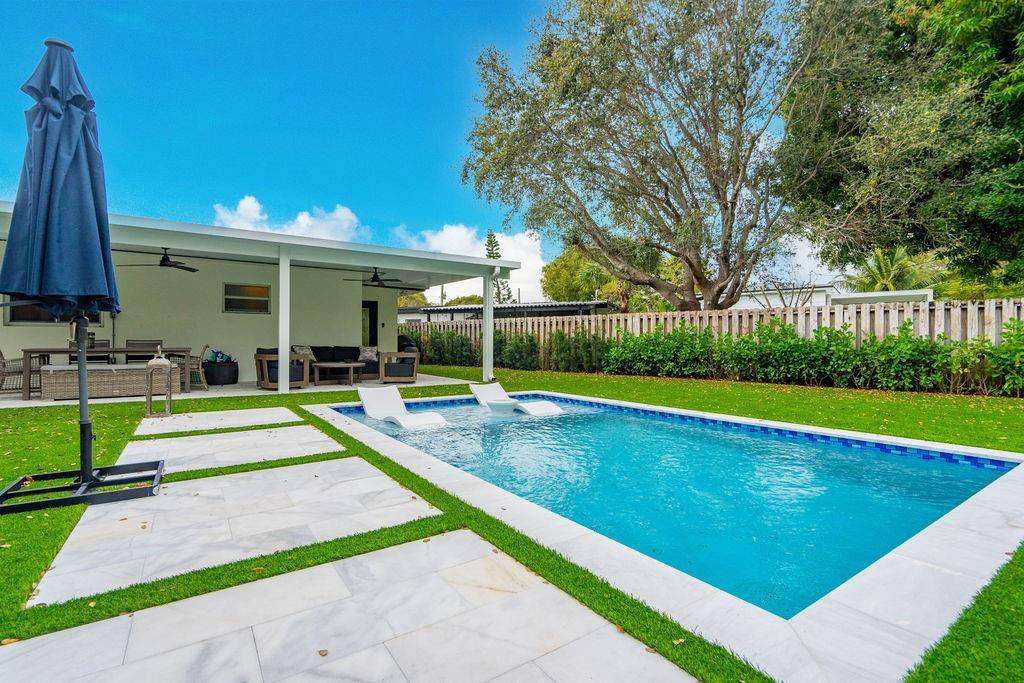 Cozy, beautifully remodeled home featuring a stunning brand new pool and expansive artificial turf yard.