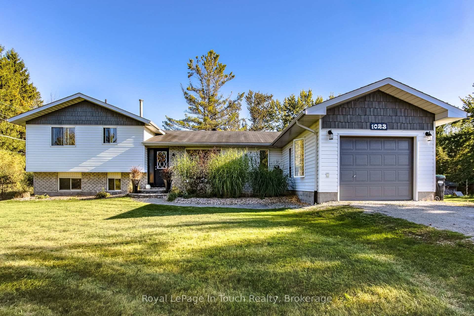 Welcome to 1023 Flos Rd 4 West in Springwater Township, a spacious family home set in a peaceful country setting just minutes north of Barrie.