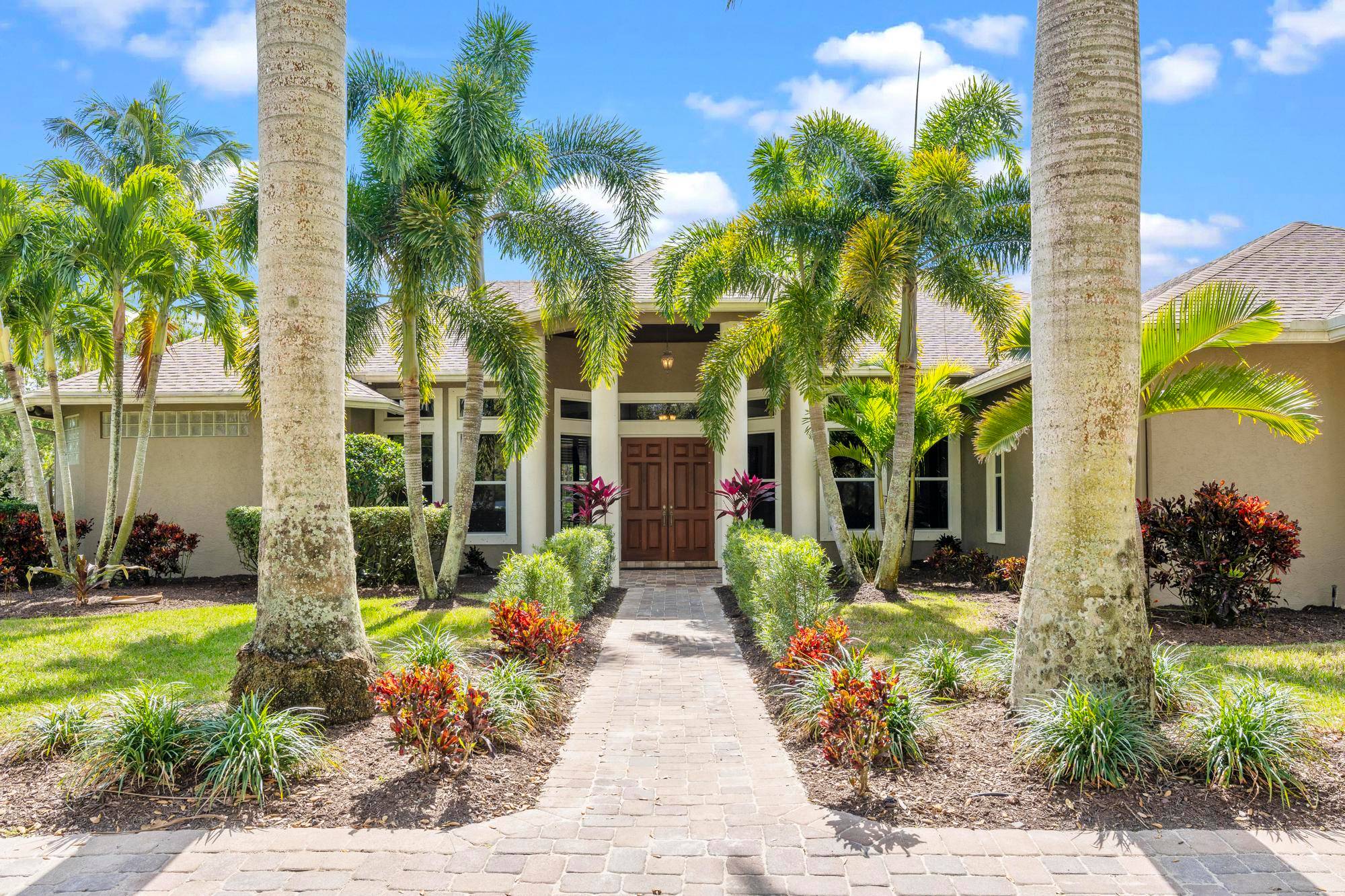 Introducing a luxurious retreat nestled in the heart of the Acreage of West Palm, this stunning 5083 square foot home offers an unparalleled blend of elegance, comfort, and functionality.