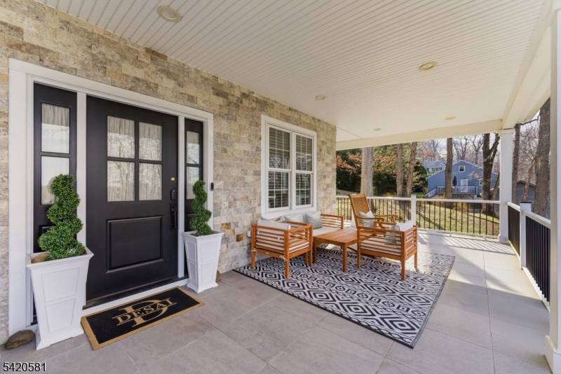 Set on an elevated lot in a peaceful, tucked away setting, this beautifully designed 5 bedroom, 4.