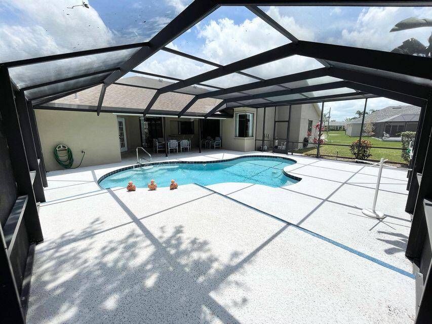 Affordable Pool Home with 3 Bedroom 2 and a half Bath features a large back yard with shed, screened pool area, split bedrooms, cabana bath, separate formal living area and ...