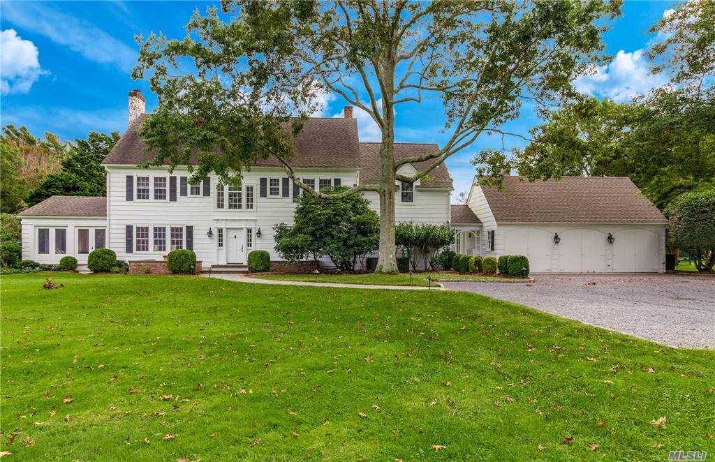 Down a private road, sits this completely renovated traditional home with 6 bedrooms and 4.