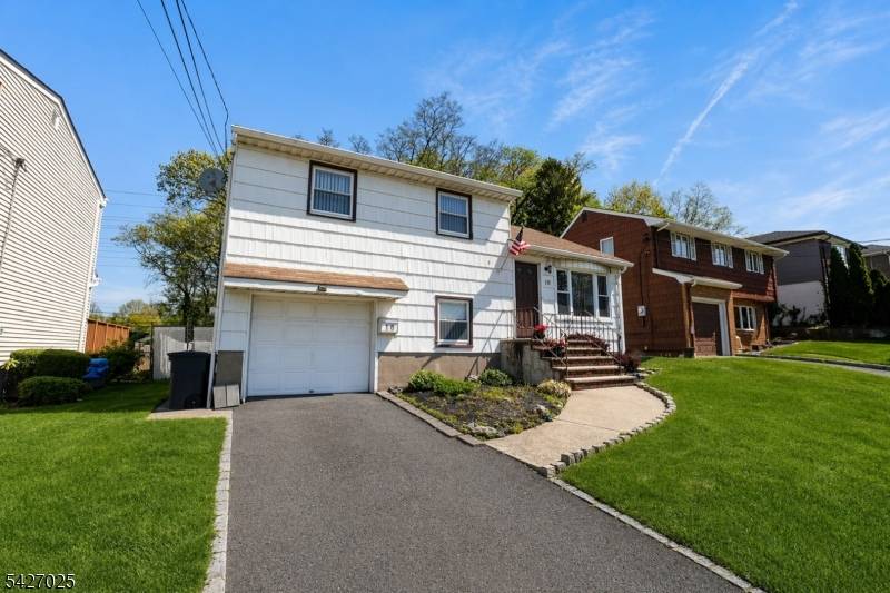 Spacious split level home offering a bright living room, formal dining room with sliding doors leading to a deck, and a well appointed kitchen.