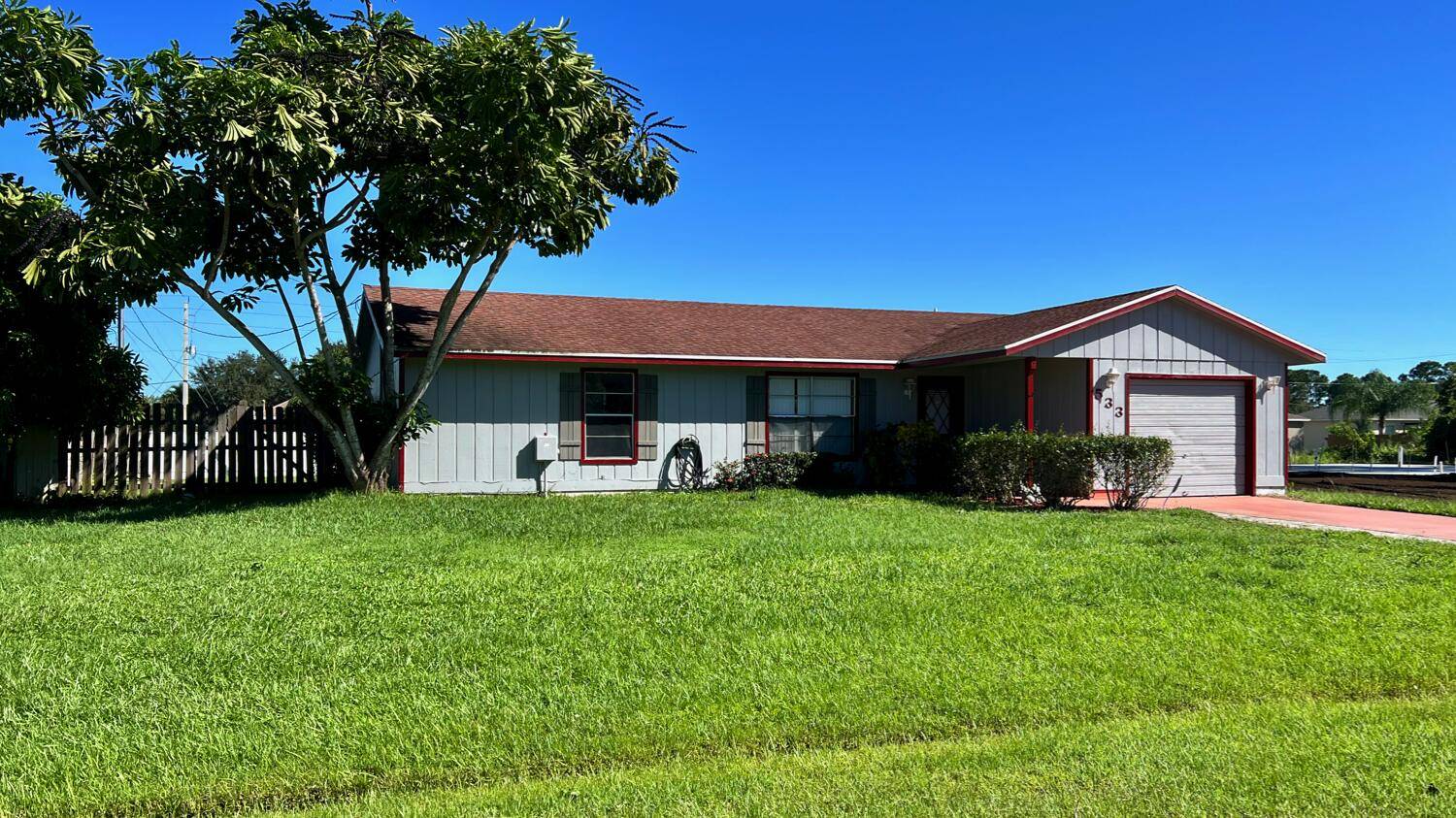 This great starter home near Saint Lucie West features an open plan with three beds, two baths, a one car garage, a covered porch, a large fenced yard, and a ...