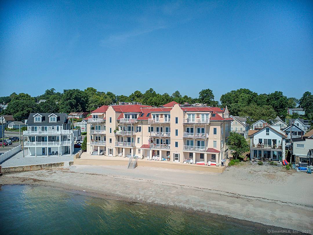 Experience the ultimate in coastal living w this stunning direct waterfront condominium, offering breathtaking views of Long Island Sound your very own private sandy beach.