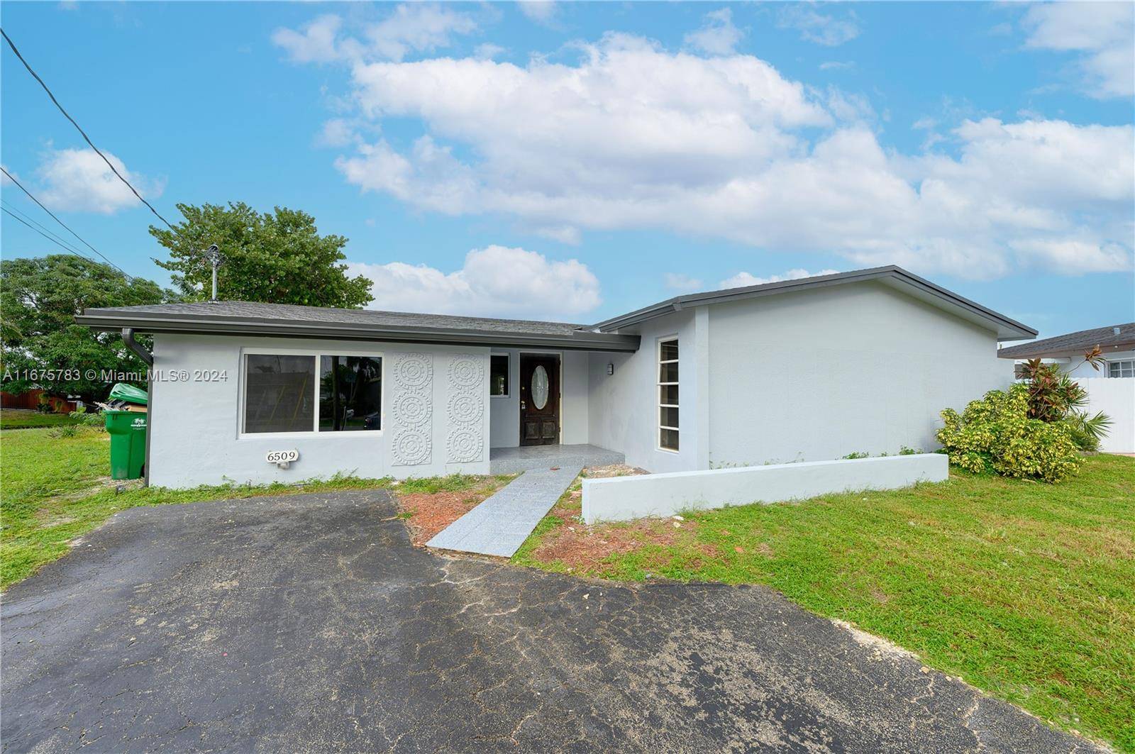 Beautiful and renovated 4 2 with den and pool on a large lakefront lot in Miramar.