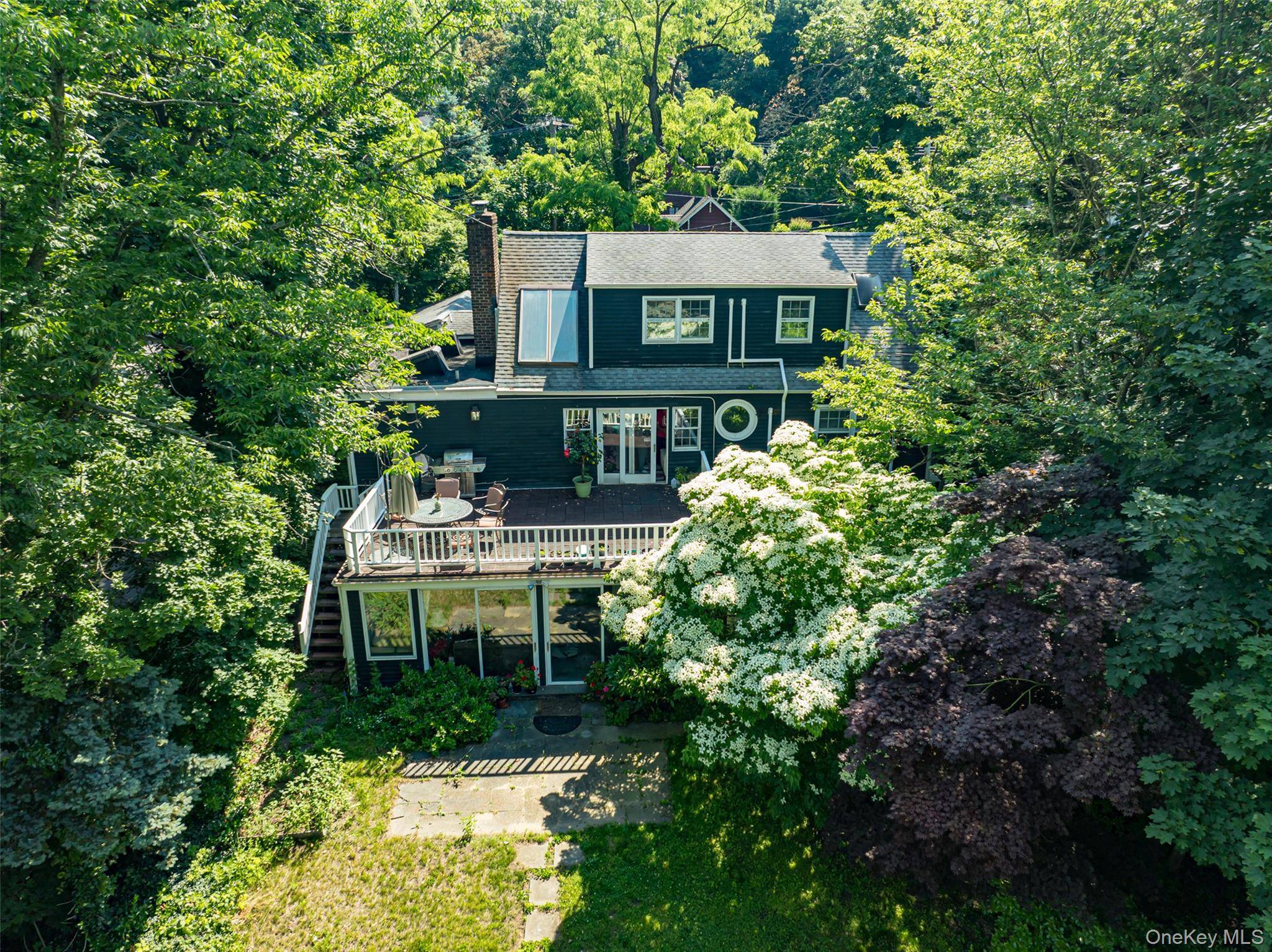 Enjoy Breathtaking Water Views of Roslyn Pond from This Unique Park like Home !