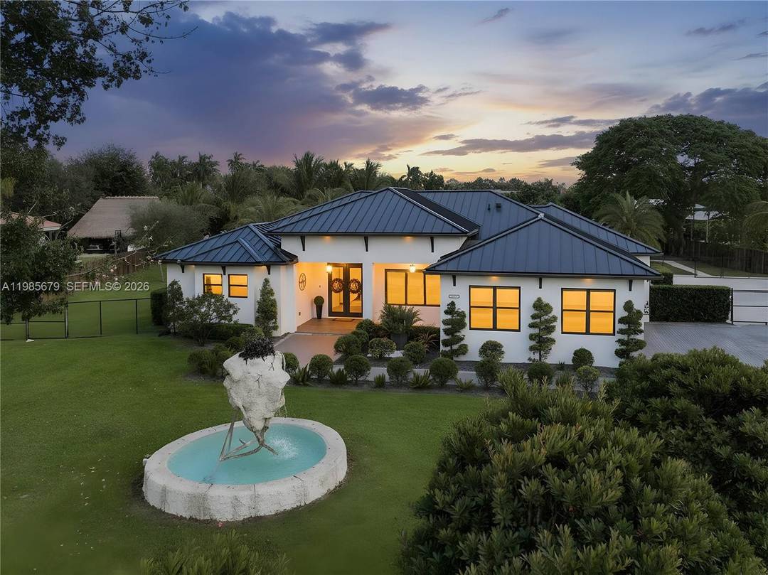 Experience luxury living in this stunning 5 bedroom, 4 bath estate situated on a private 1.