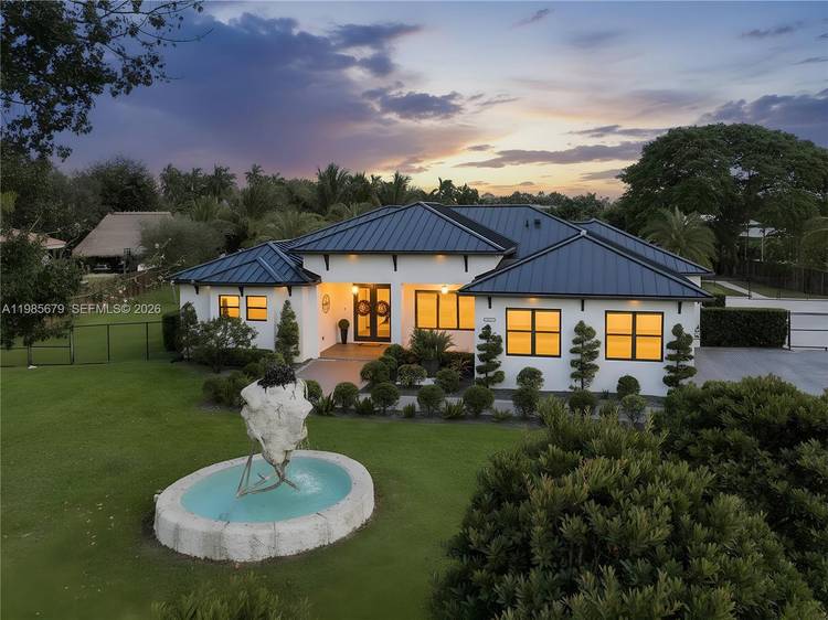 Experience luxury living in this stunning 5 bedroom, 4 bath estate situated on a private 1.